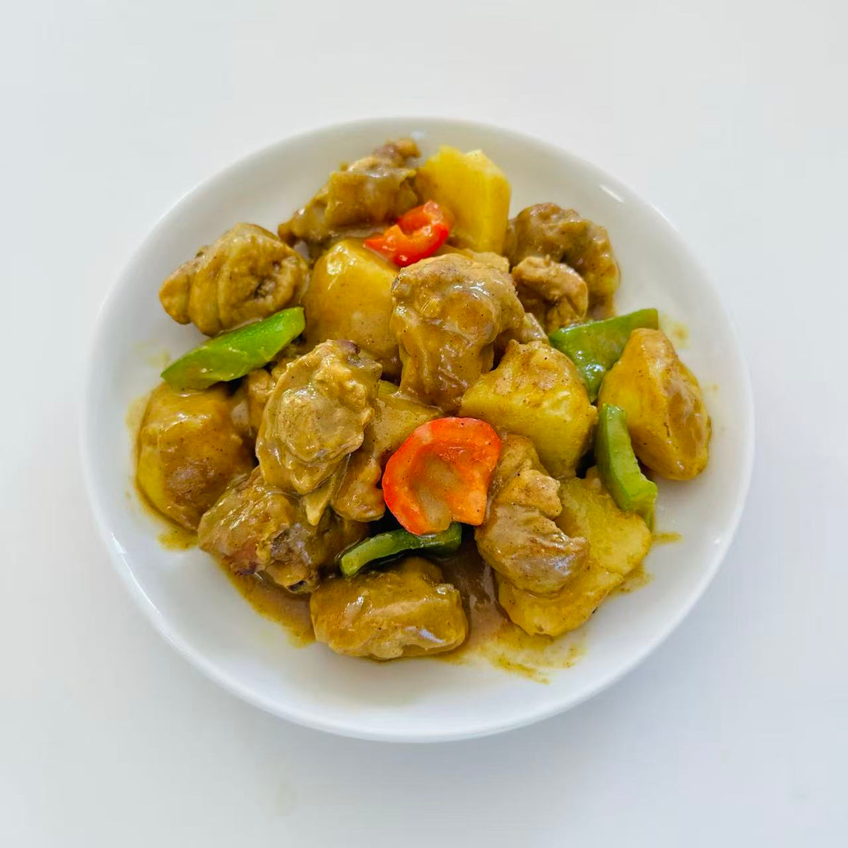 Boneless Curry Chicken with Potato in a 16 oz Family Meals container.