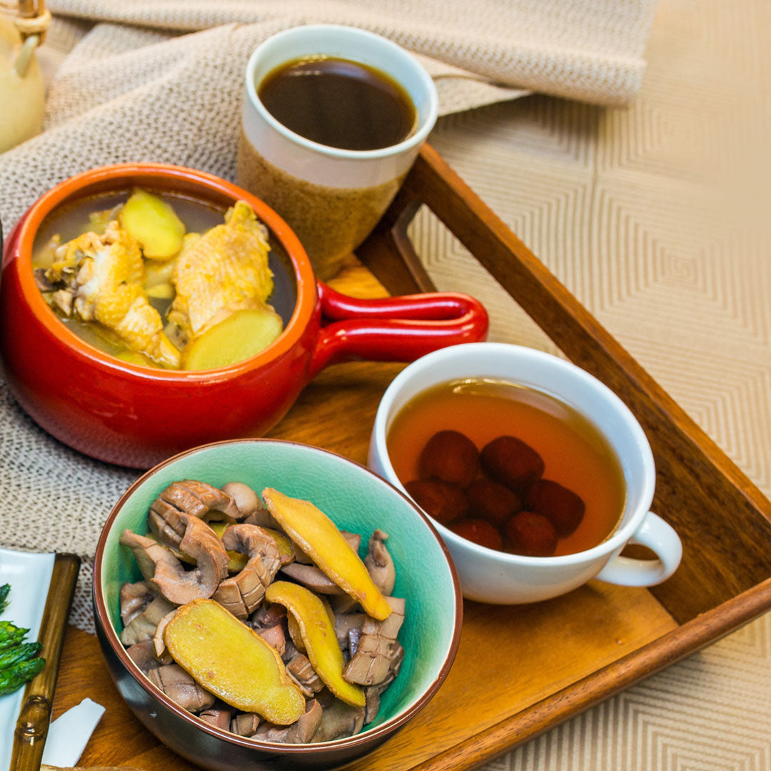 Chinese-inspired recovery meal with chicken, vegetables, red dates and herbal tea