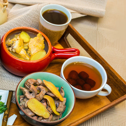 Chinese-inspired recovery meal with chicken, vegetables, red dates and herbal tea