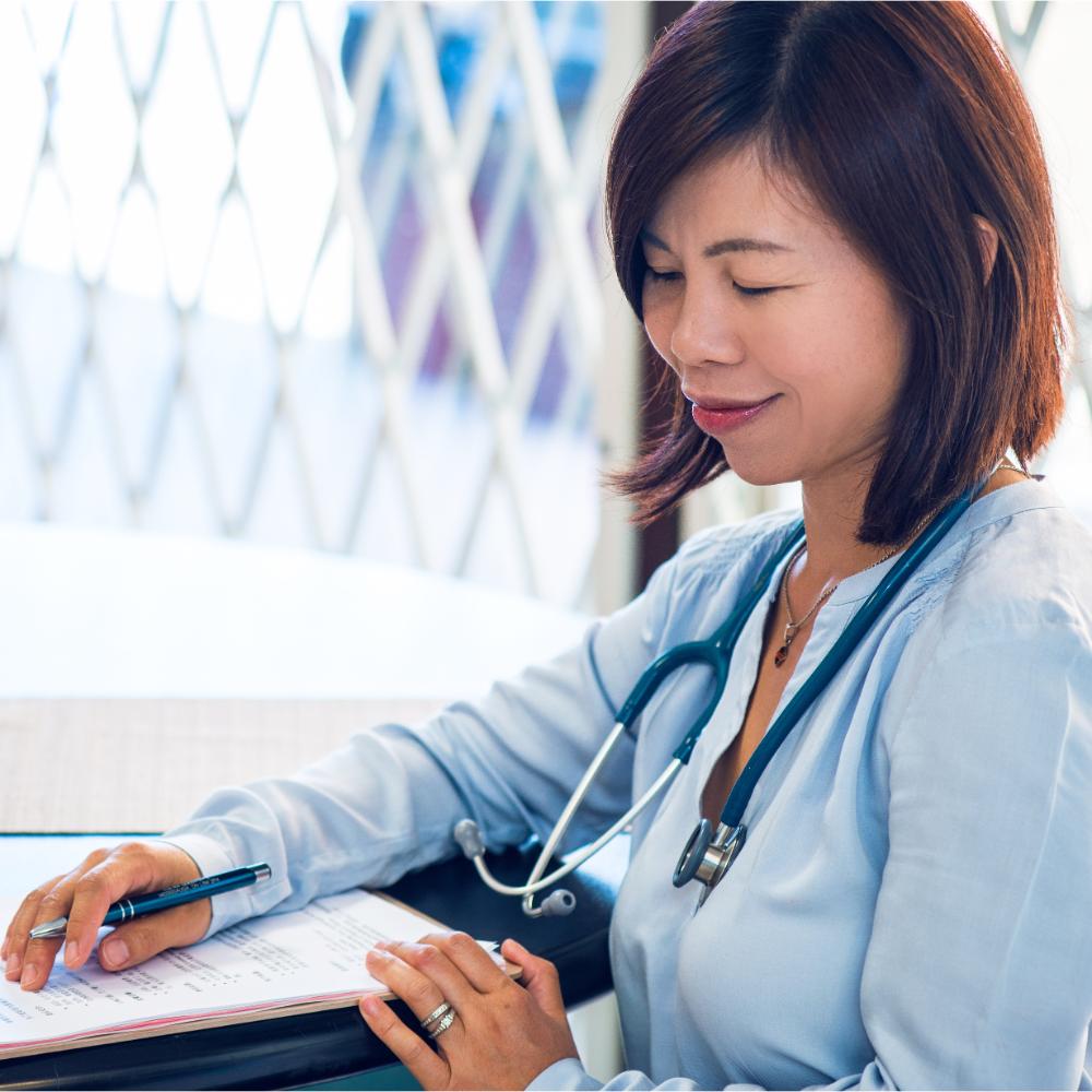 Healthy7 founder and nurse reviewing notes as part of professional family support