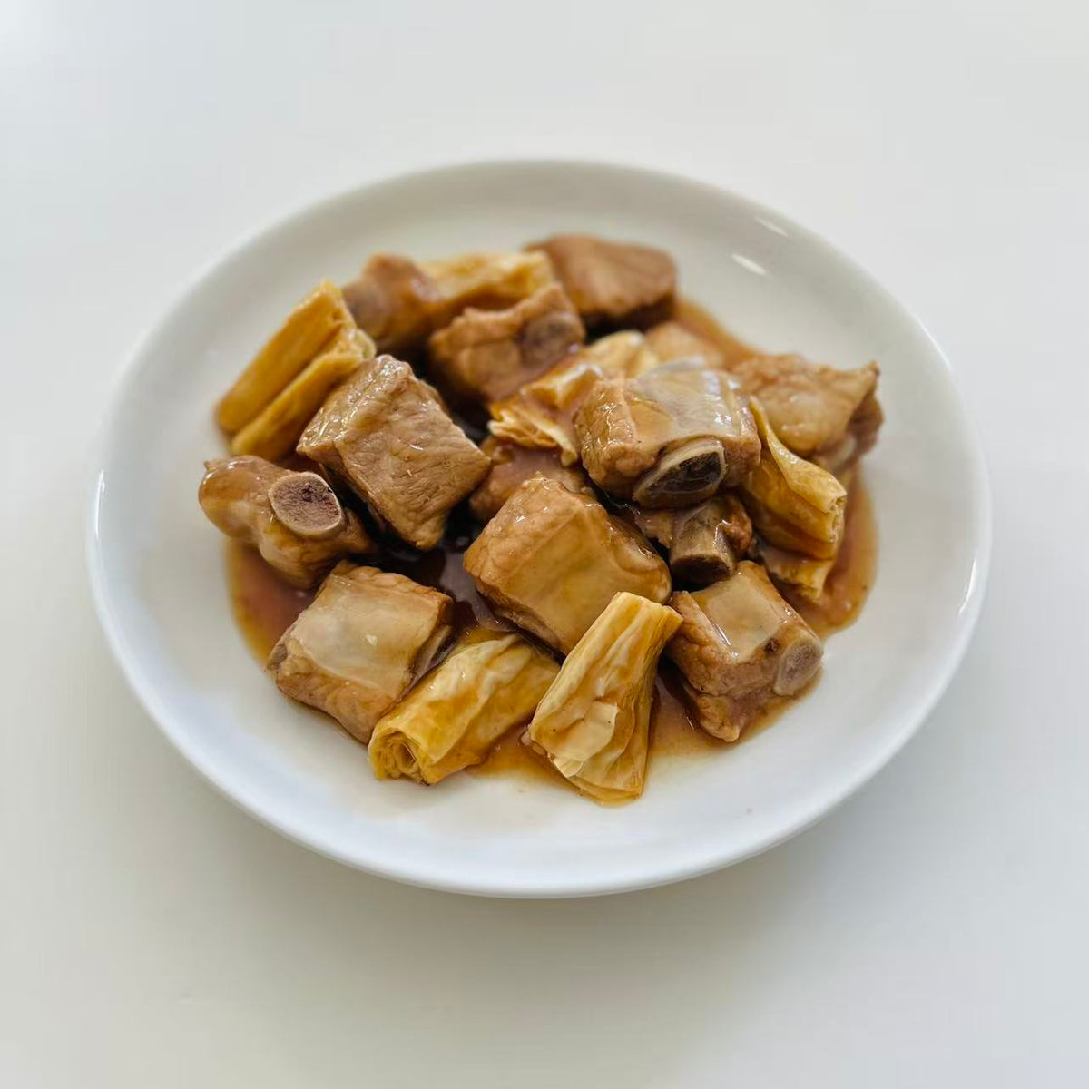 Braised Pork Ribs with Bean Curd Sticks in a 16 oz Family Meals container.