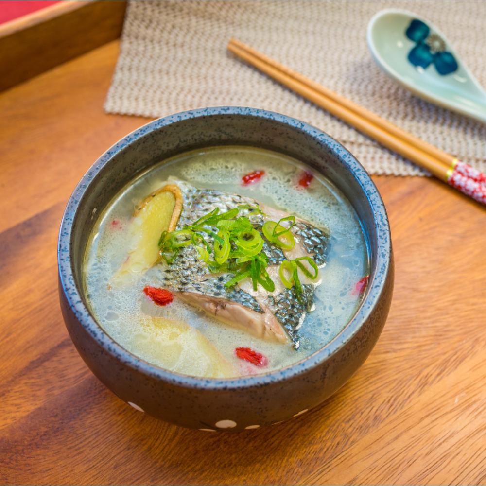 Fish soup with ginger, goji berries and green onion