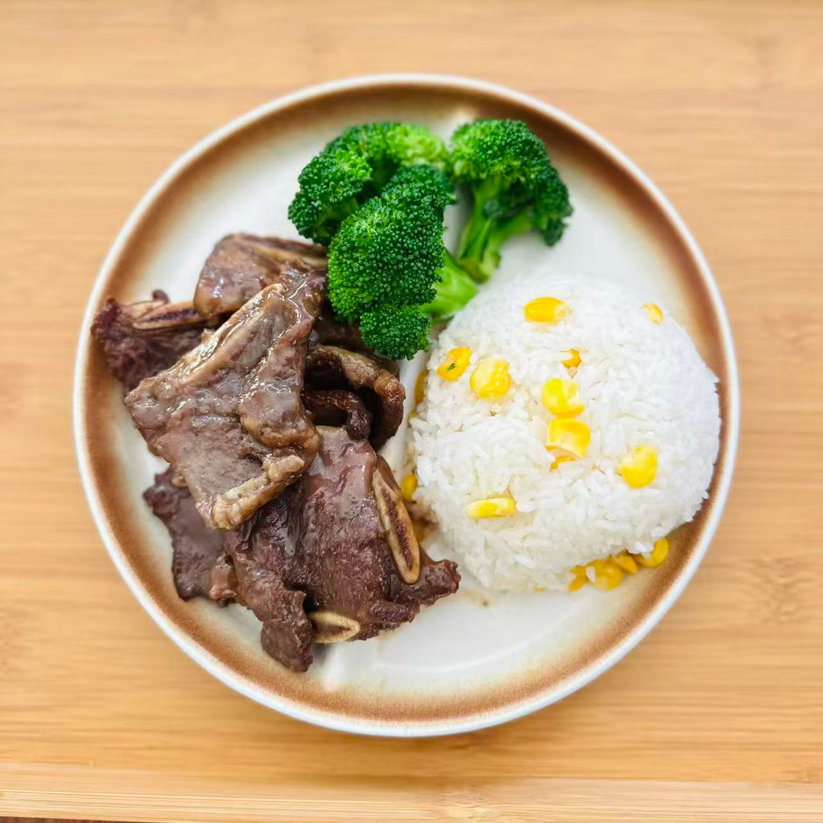 Korean BBQ Beef Short Ribs with mixed rice and vegetables in a meal container.