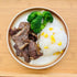 Korean BBQ Beef Short Ribs with mixed rice and vegetables in a meal container.