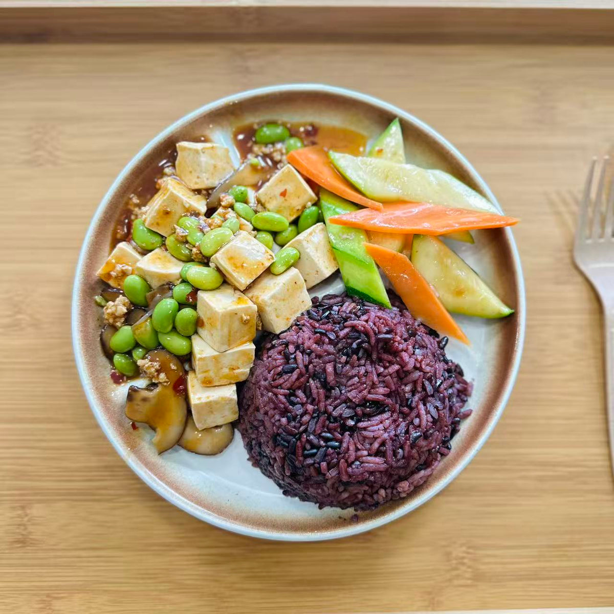 Mapo Tofu with mixed rice and vegetables in a meal container.