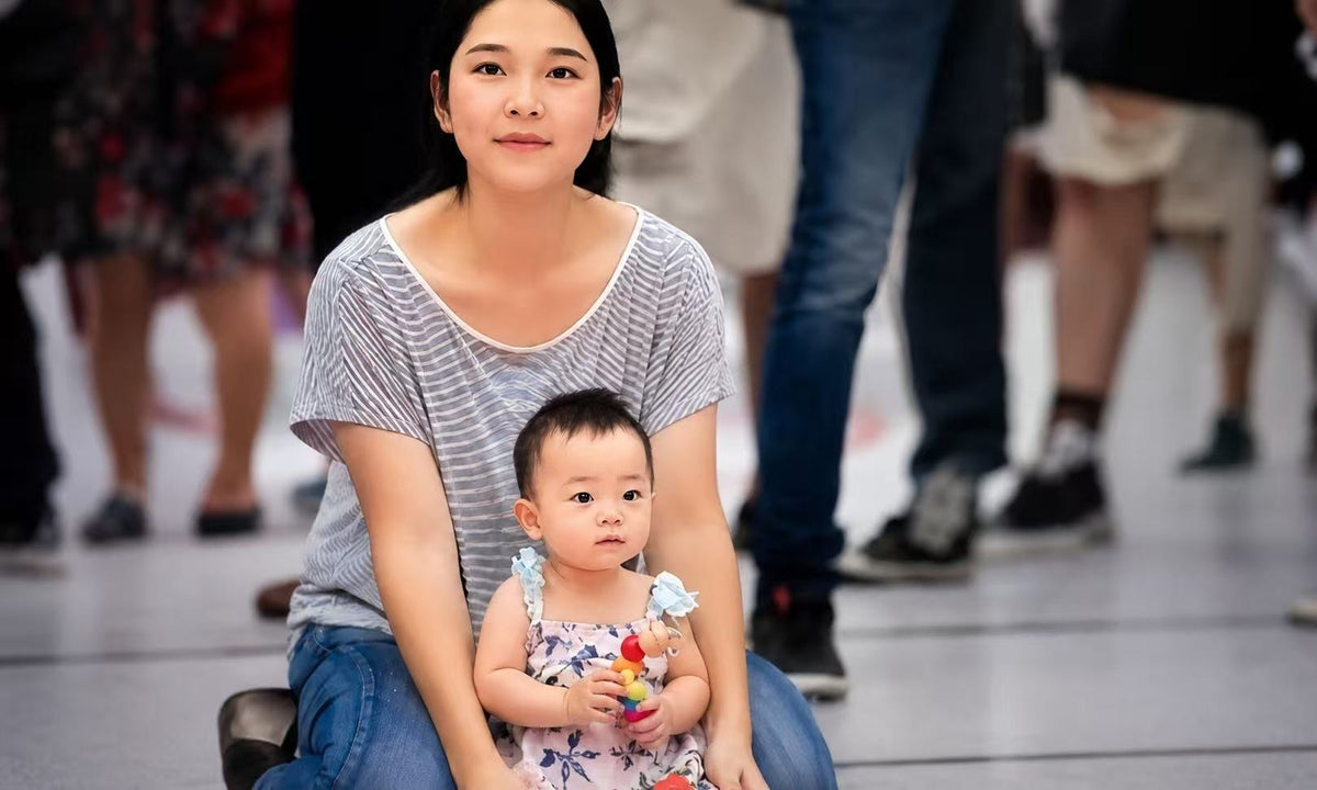 A mother with her child during the early years of her motherhood journey