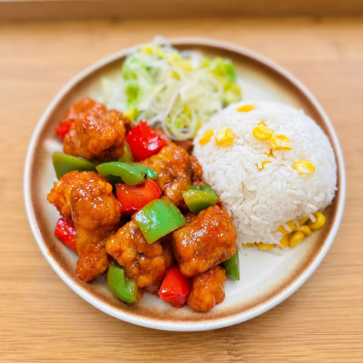 Sweet &amp; Sour Pork with mixed rice and vegetables in a meal container