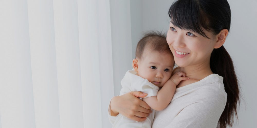 Mother holding her baby during the early postpartum period